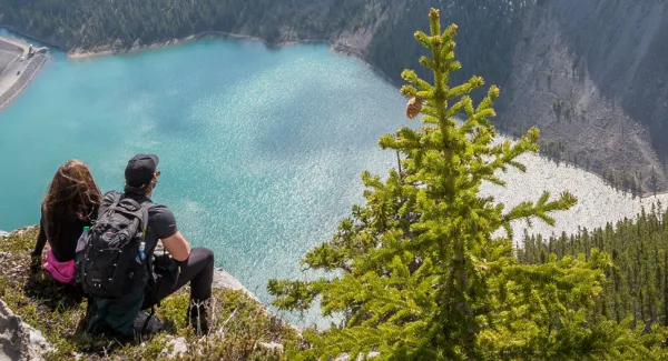 couple visiting a moutain lake with a rental motorhome