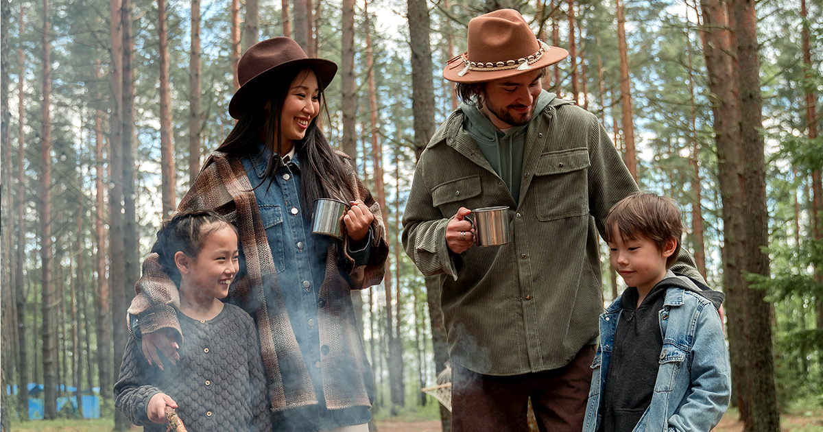 happy family by a campfire in the woods