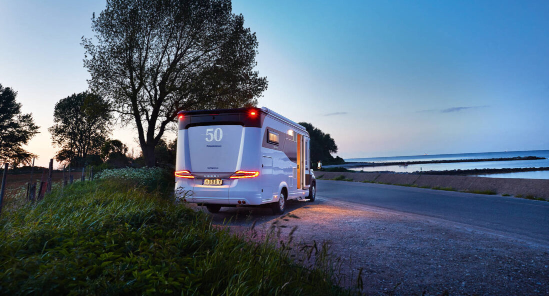 exterior_luxury motorhome roadside at nightfall-hobby